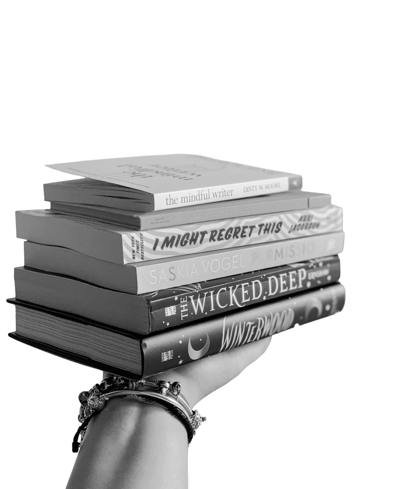 Hand holding stack of books